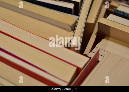 reading concept: stack of old books with paper turned up Stock Photo