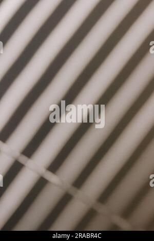 Shadow from the window blinds on the wall, abstract background or overlay Stock Photo