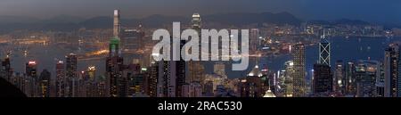 Hong Kong, China - March 26 2014: Kowloon and Victoria Harbour viewed from Victoria Peak at dusk. Stock Photo