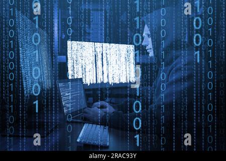 Anonymous man in mask with computers and binary code in darkness Stock Photo