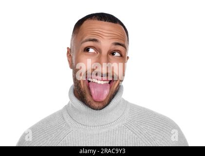 Happy young man showing his tongue on white background Stock Photo