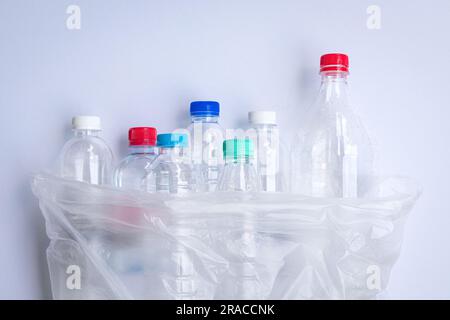 Plastic bottles inside a plastic bag. On white background. Stock Photo