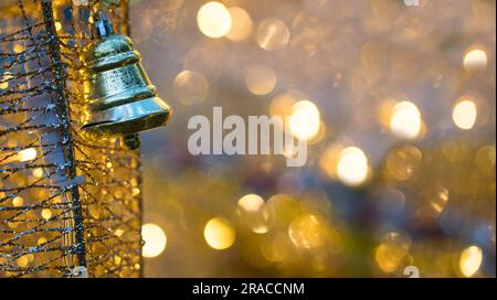 Hanging silver bell with light bokeh background. Copy space. Stock Photo