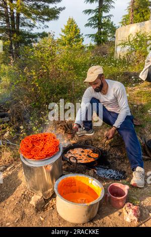 June 28th 2023 Uttarakhand, India. A young Man making Pakodas and Jalebis ( Indian traditional cuisine ) during a Fair Festival (mela). Village in the Stock Photo