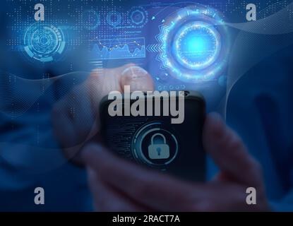 Man in blue shirt holds mobile phone. Symbols and icons of mobile internet, social networks, emails, cloud storage, multimedia services and so on. Mob Stock Photo