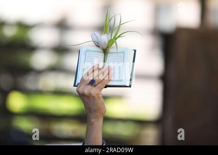 Tehran, Iran. 30th June, 2023. An Iranian demonstrator holds up a copy of Quran, Islam's holy book, during a protest of the burning of a Quran in Sweden, in front of the Swedish Embassy in Tehran, Iran, Friday, June 30, 2023. On Wednesday, a man who identified himself in Swedish media as a refugee from Iraq burned a Quran outside a mosque in central Stockholm. (Photo by Sobhan Farajvan/Pacific Press/Sipa USA) Credit: Sipa USA/Ģ����ý Live News Stock Photo