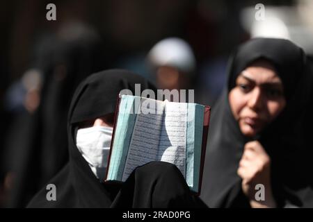 Tehran, Iran. 30th June, 2023. An Iranian demonstrator holds up a copy of Quran, Islam's holy book, during a protest of the burning of a Quran in Sweden, in front of the Swedish Embassy in Tehran, Iran, Friday, June 30, 2023. On Wednesday, a man who identified himself in Swedish media as a refugee from Iraq burned a Quran outside a mosque in central Stockholm. (Photo by Sobhan Farajvan/Pacific Press/Sipa USA) Credit: Sipa USA/Ģ����ý Live News Stock Photo