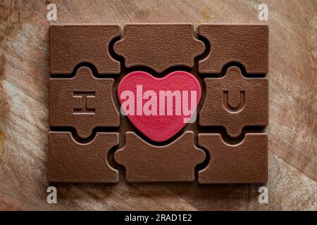 Valentine's Day chocolate puzzle with red heart in the middle Stock Photo