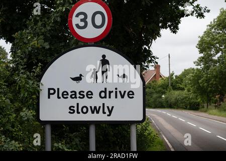 Please drive slowly sign with camel, Old MIlverton village, Warwickshire, England, UK Stock Photo