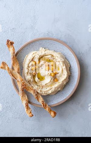 Hummus with sesame bread sticks Stock Photo