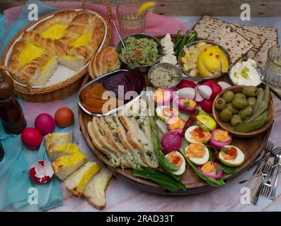 Easter brunch with Eastern European pasca bread, deviled eggs, pickles, spreads and crudites Stock Photo