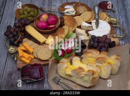 Vegetarian Easter brunch with various breads, eggs, cheese, fruit and cucumbers Stock Photo