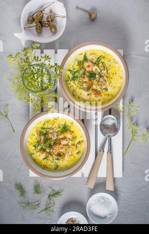 Creamy seafood chowder with smoked haddock, praws, mussels, squid and dill Stock Photo
