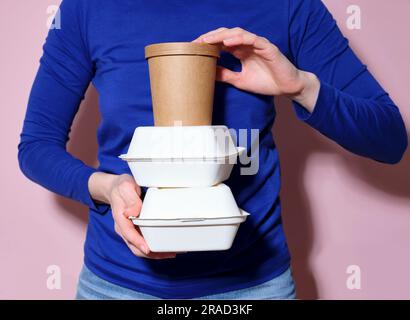 Person holding take-out containers Stock Photo