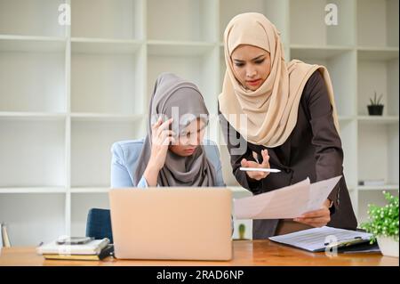 Professional Muslim business team working together, discussing on an important project in the office room. Stock Photo