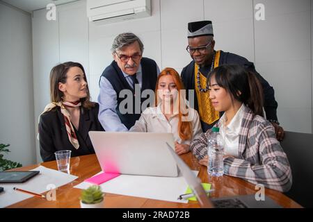 Colleagues working on a project in an office, multi-ethnic group Stock Photo