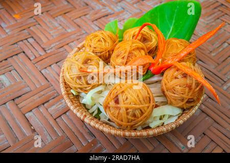 Deep fried wrapped pork with noodle. Traditional thai food as known as Mhoo Sarong. Stock Photo