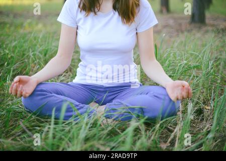 Woman practising yoga outdoors Stock Photo