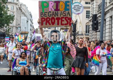 London, UK. 1st July, 2023. A participant holds up a sign reading Pride Began As A Protest during the Pride in London parade. Over a million people watched the 51st annual Pride parade in which an estimated 30,000 people took part from over 600 organisations including many LGBT+ community groups. Credit: Mark Kerrison/Alamy Live News Stock Photo