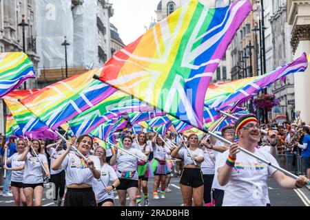 London, UK. 1st July, 2023. Participants perform with large Rainbow Union Jacks during the Pride in London parade. Over a million people watched the 51st annual Pride parade in which an estimated 30,000 people took part from over 600 organisations including many LGBT+ community groups. Credit: Mark Kerrison/Alamy Live News Stock Photo