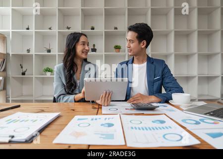 Two business people talk project strategy at office meeting room. Businessman discuss project planning with colleague at workplace while having Stock Photo