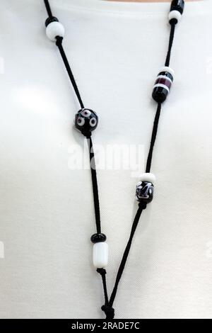 Black color and white color glass necklace on girl Stock Photo