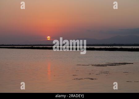 Zen landscape over reddish sunset in the Salinas de Santa Pola, Spain Stock Photo