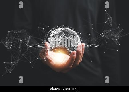 A businessman's hand holds a globe, illustrating seamless connectivity and data flow across global network Stock Photo