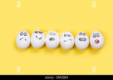 Don't put all of your eggs in one basket background. Funny eggs with different mood faces. July 9 - National Dont Put All Your Eggs in One Omelet Day Stock Photo