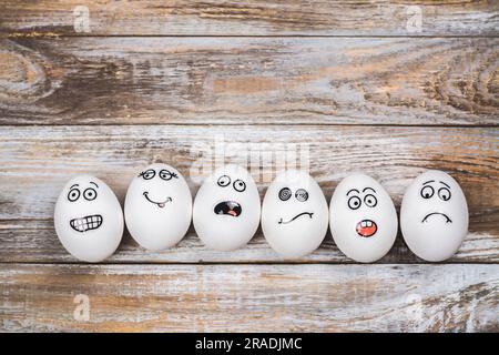 Don't put all of your eggs in one basket background. Funny eggs with different mood faces. July 9 - National Dont Put All Your Eggs in One Omelet Day Stock Photo
