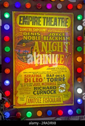 An Empire Theatre poster advertising a stage production, displayed within an illuminated frame surrounded by coloured lights Stock Photo