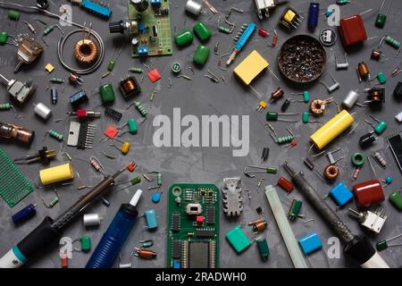 Different electronic components and equipment. flat lay with space for text on gray concrete background. set of spare parts DIY. Stock Photo