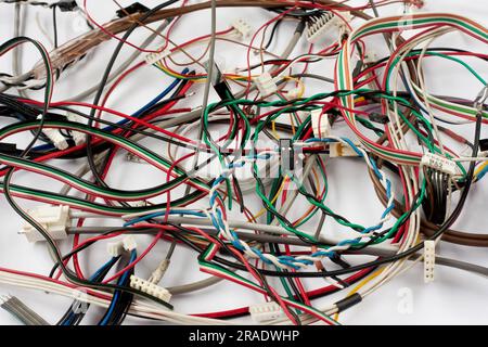 Colored cables and wires with connectors on white background. Chaos of colorful different computer and other wires and Internet network. Telecommunica Stock Photo