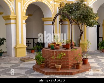 Nice water well made of bricks decorating an old patio Stock Photo