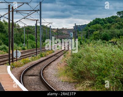 Empty and deserted railway lines or tracks on the approach to Grantham train station on a stormy summer afternoon Stock Photo