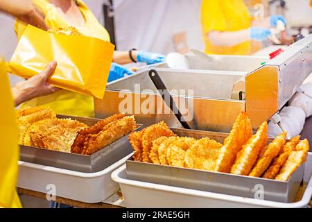 pack a delicious hot cheburek in edible yellow paper. Street food, food to go Stock Photo