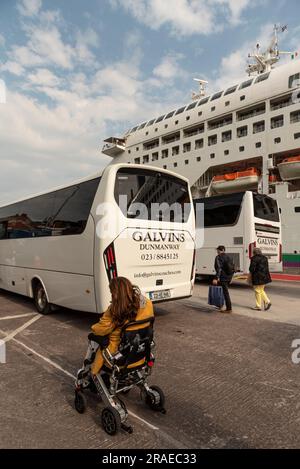 Cobh, Ireland, EU. 9 June 2023.  Cruise passengers exiting a excursion coach and returning to their cruise ship alongside in Cobh Harbour, Ireland. Stock Photo