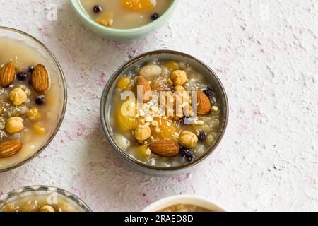 Traditional Turkish Dessert Ashure  or Noah's Puding in bowls designed on decorative surface.with copy space.Top view Stock Photo