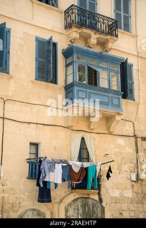 Traditional apartment buildings in Valletta, Malta with washing hanging out to dry Stock Photo