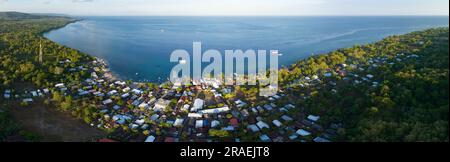 Morning sunlight illuminates a fishing village on the beautiful island of Moyo found just off the north coast of Sumbawa in Indonesia. Stock Photo