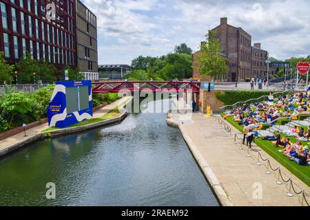 London, UK. 3rd July 2023. Crowds watch Wimbledon on a large outdoor screen next to Regent's Canal in King's Cross as this year's tennis championship begins. Stock Photo