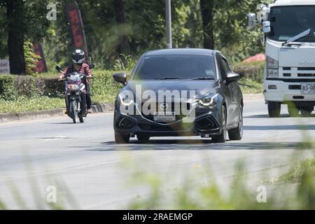 Chiangmai, Thailand -   June  1 2023: Private Eco car Mazda 2. On road no.1001 8 km from Chiangmai Business Area. Stock Photo