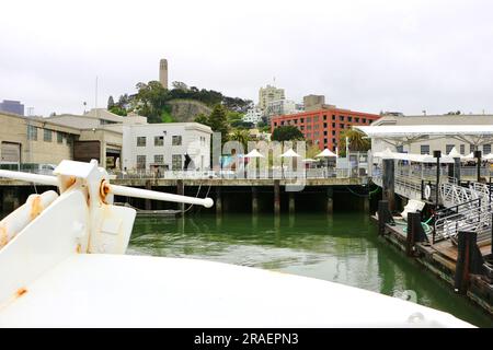 Leaving Pier 33 in reverse on board the Alcatraz Clipper tour boat with the iconic Coit Tower San Francisco California USA Stock Photo