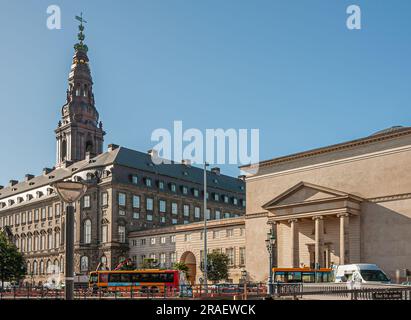 Copenhagen, Denmark - September 15, 2010: Christiansborg palace under its tall bell tower with golden decorations and adjacent palace church under blu Stock Photo