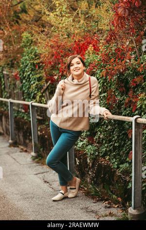 Autumn portrait of beautiful young woman, wearing warm beige pullover Stock Photo