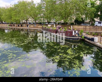 London, UK - June 2023 : Waterbus arrives at Little Venice. Coffee shop in a barge seen from,the bridge. Stock Photo