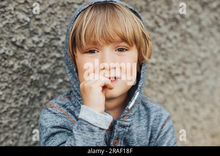 Stressed child biting finger nails, sad toddler boy Stock Photo