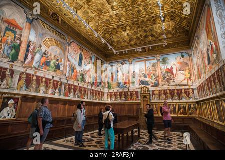 Sala Capitular Toledo, view of people looking at the portraits, frescoes and fine artesonado ceiling in the Cathedral Chapter House, Toledo, Spain Stock Photo