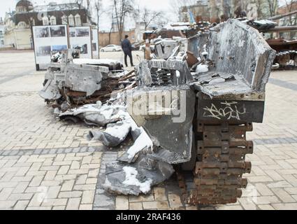Civilian car shot by Russian soldiers. War in Ukraine. Destroyed russian tank on the Mykhailivs'ka Square. Stock Photo