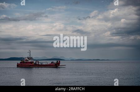 landscape photograph of a vessel on the west coast of scotland, on a calm cloudy day. Stock Photo